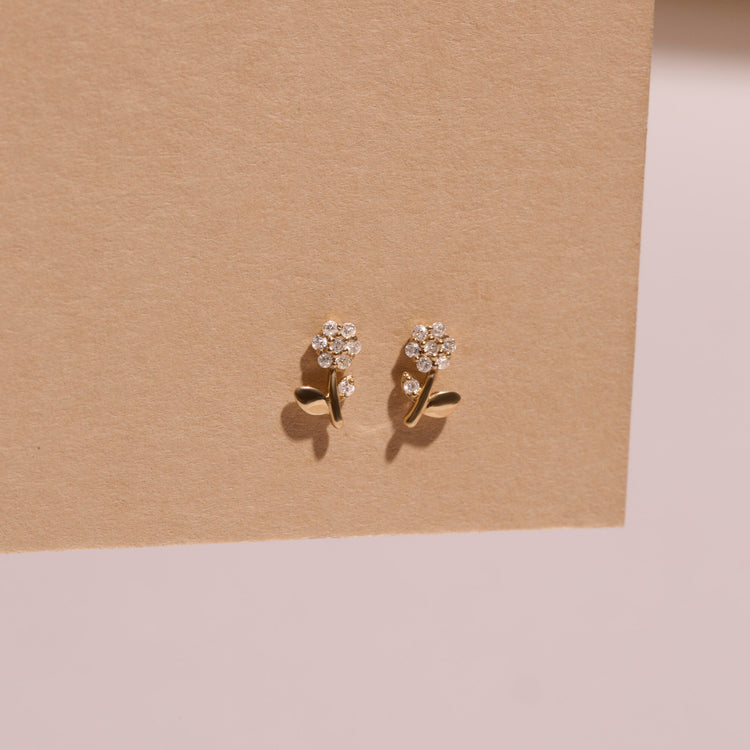 Stone and Strand 14K Yellow Gold Blooming Diamond Flower Studs Editorial Image
