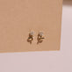 Stone and Strand 14K Yellow Gold Blooming Diamond Flower Studs Editorial Image