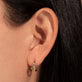 Image of 10K Yellow Gold Blue Wildflower Huggie with Gemstones on Models Ear