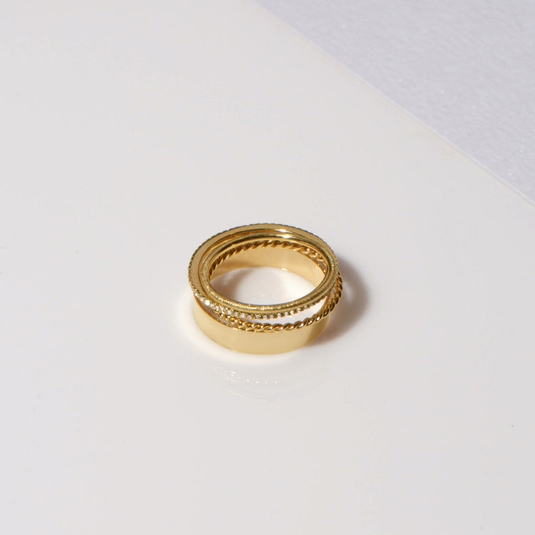 Still life image of Bold Gold Twist Ring with Stone and Strand solid gold jewelry