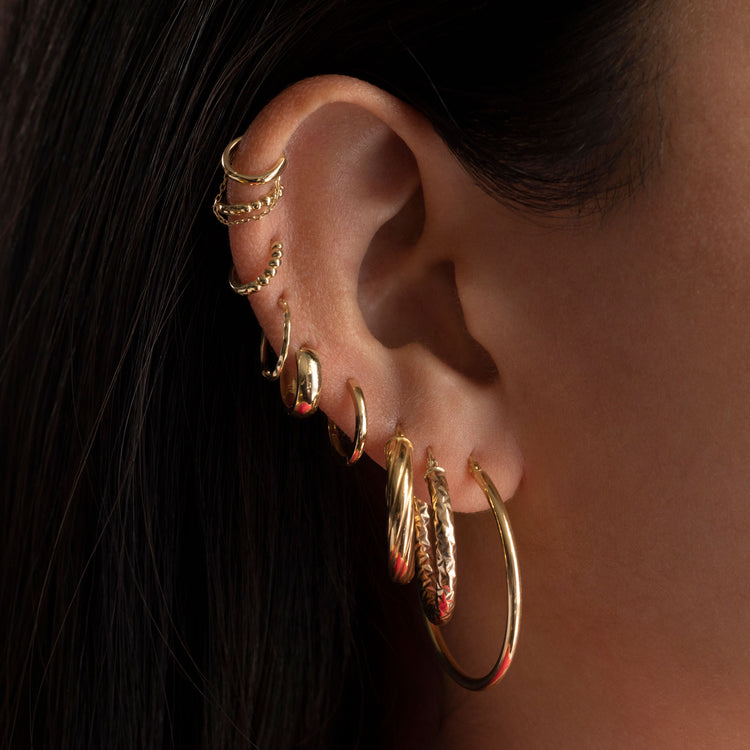 Model wearing Bold Sparkle Hoops with solid gold Stone and Strand jewelry