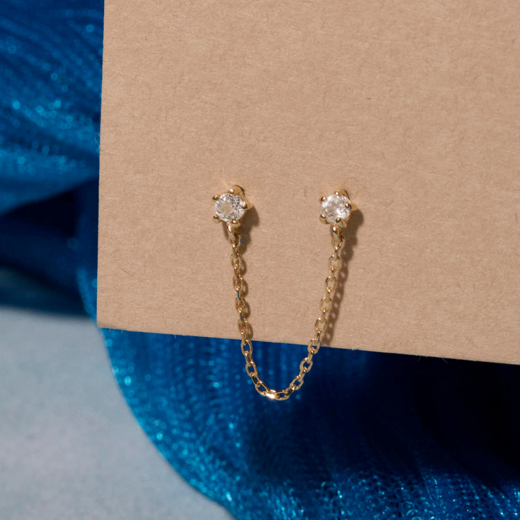 Stone and Strand 10K Yellow Gold Chained Topaz Double Earring Editorial Image