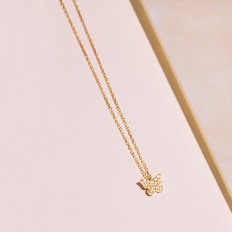 Stone and Strand 14K Yellow Gold Diamond Butterfly Pendant Editorial Image
