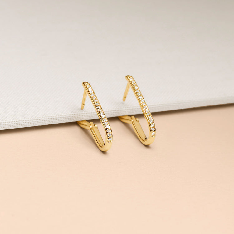 Stone and Strand 10K Yellow Gold Small Diamond Oval Earrings Editorial Image
