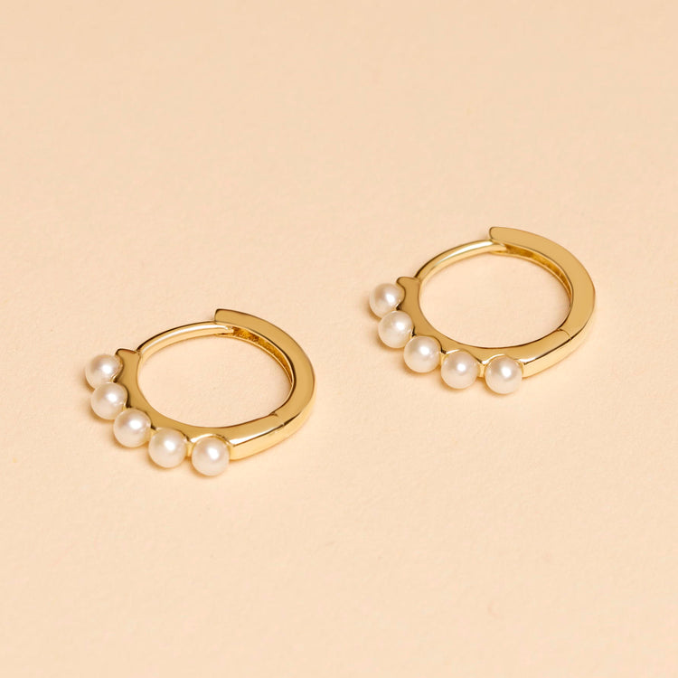 Stone and Strand 14K Yellow Gold Dainty Dive Deep Pearl Huggies Editorial Image