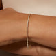 Image of 10K Yellow Gold Drop Shot Diamond Tennis Bracelet on Models Arm