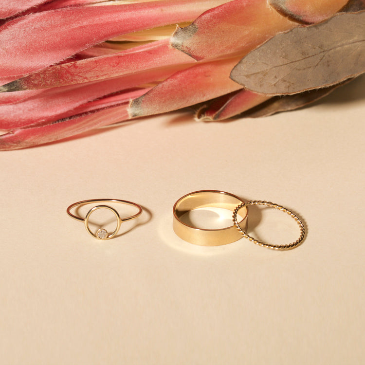 Still life image of Gold Cigar Band with Stone and Strand solid gold jewelry