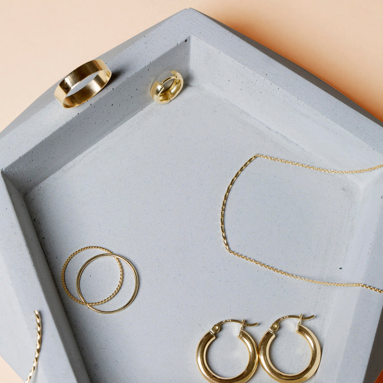 Still life image of Fine Gold Twist and Round Interlocking Band with Stone and Strand solid gold jewelry