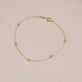 Stone and Strand 10K Yellow Gold Golden Beads Bracelet Editorial Image
