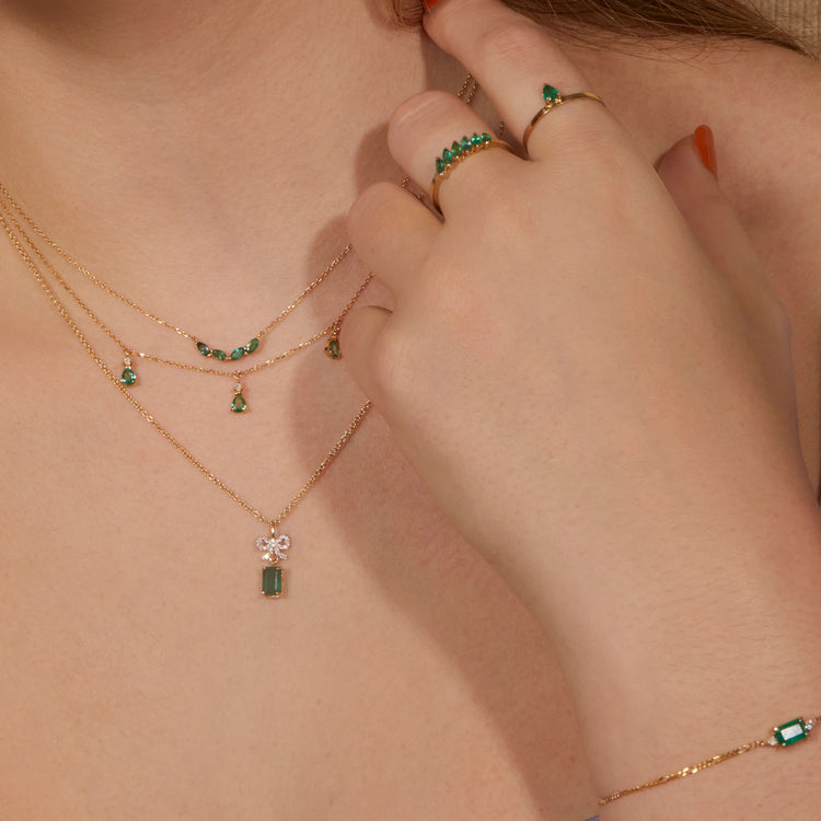 Model wearing Green Goddess Bracelet with solid gold Stone and Strand jewelry