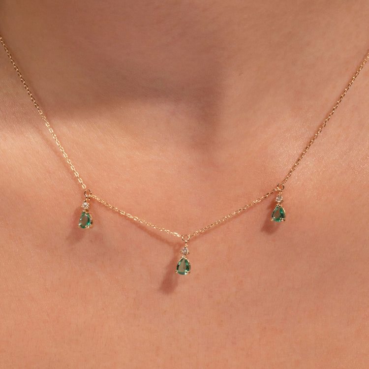 Image of 10K Yellow Gold Green Goddess Trio Necklace with Emerald on Models Neck