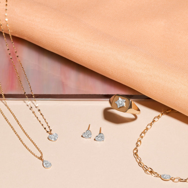 Still life image of Heart of the Matter Diamond Earrings with Stone and Strand solid gold jewelry