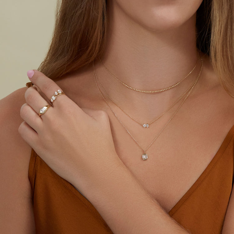 Model wearing Large Lab-Created Diamond Soiree Signet with solid gold Stone and Strand jewelry