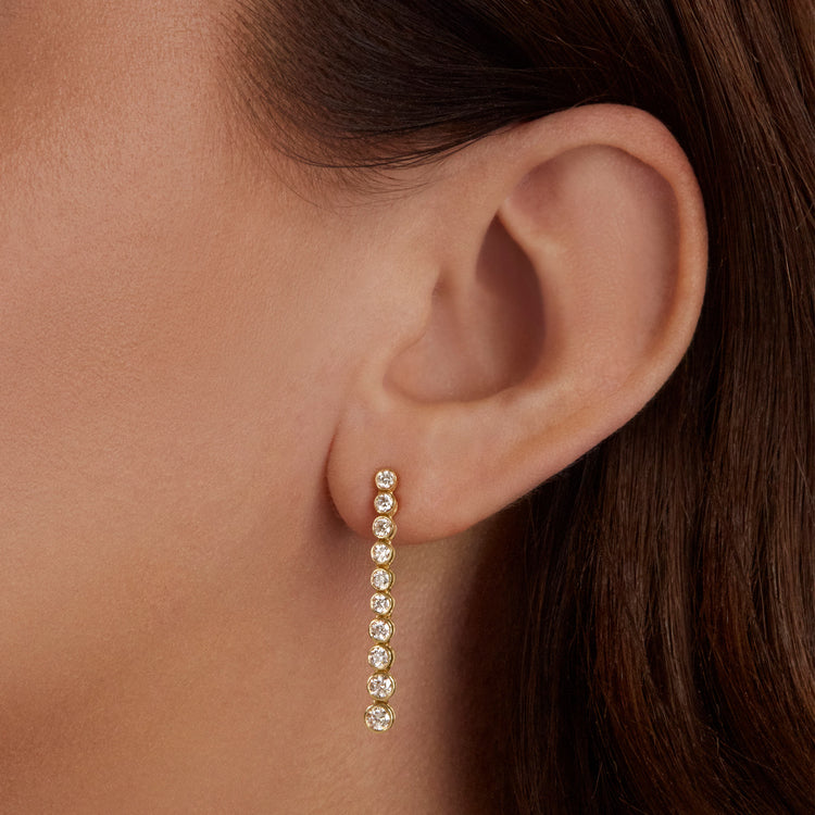 Image of 10K Yellow Gold Let It Slide Tennis Earrings on Models Ear
