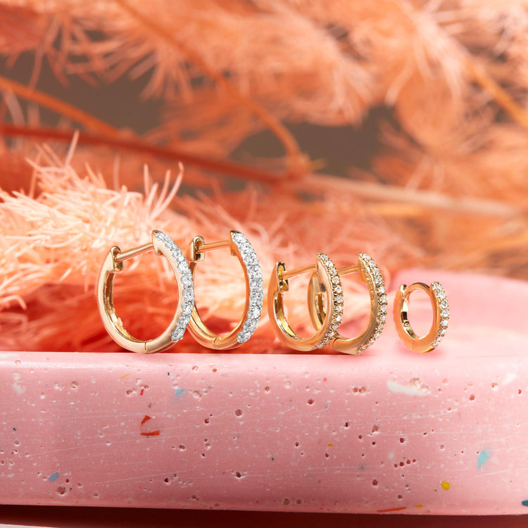 Still life image of Diamond Pave Huggie Earrings with Stone and Strand solid gold jewelry