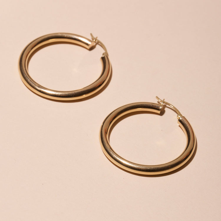 Stone and Strand 14K Yellow Gold Medium Hollow Hoop Earrings Editorial Image