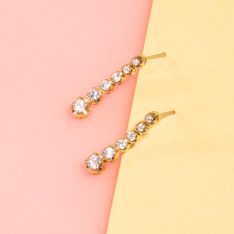 Stone and Strand 10K Yellow Gold Noble Diamond Tennis Earrings Editorial Image