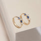 Stone and Strand 10K Yellow Gold Out Of The Blue Diamond and Blue Sapphire Huggies Editorial Image
