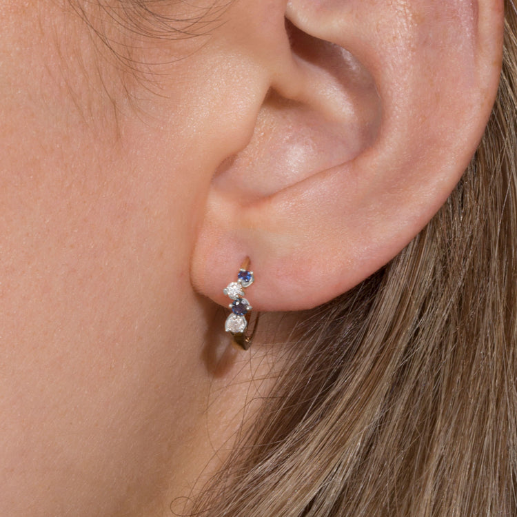 Image of 10K Yellow Gold Out Of The Blue Diamond Huggies with Blue Sapphire on Models Ear