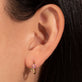 Image of 10K Yellow Gold Pink Wildflower Huggie with Gemstones on Models Ear
