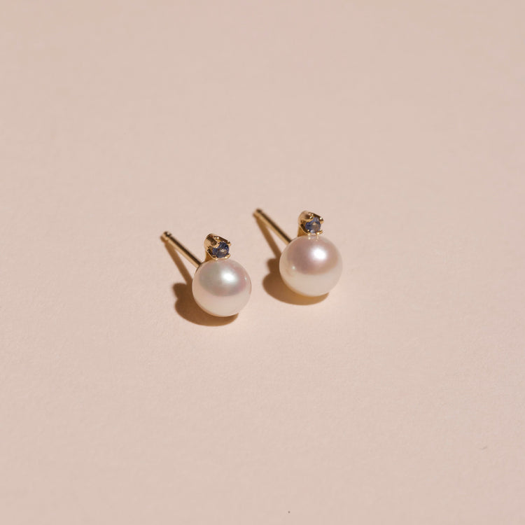 Stone and Strand 14K Yellow Gold Small Pearl and Sapphire Stud Earrings Editorial Image