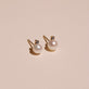 Stone and Strand 14K Yellow Gold Small Pearl and Sapphire Stud Earrings Editorial Image