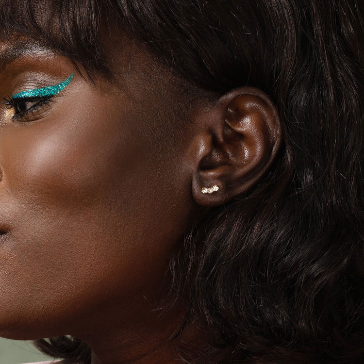 Image of 10K Yellow Gold Medium Sapphire Shimmer Curve Studs on Models Ear