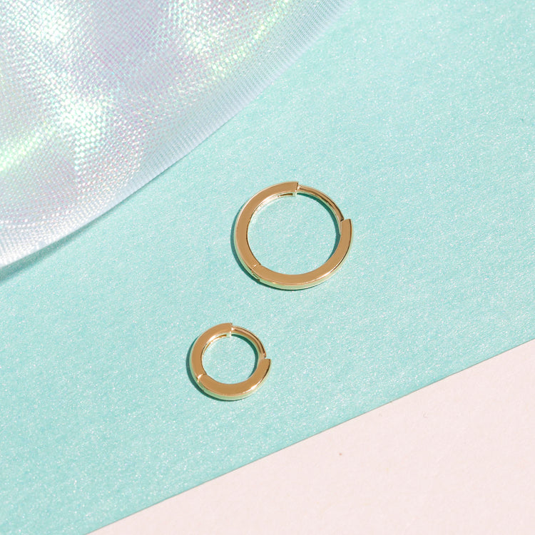 Still life image of Second Hole Teeny Gold Huggie Clicker Earring with Stone and Strand solid gold jewelry