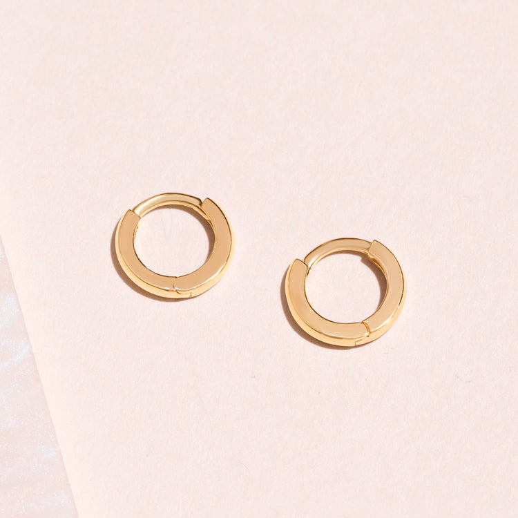 Stone and Strand 14K Yellow Gold Second Hole Teeny Gold Huggie Clicker Earring Editorial Image
