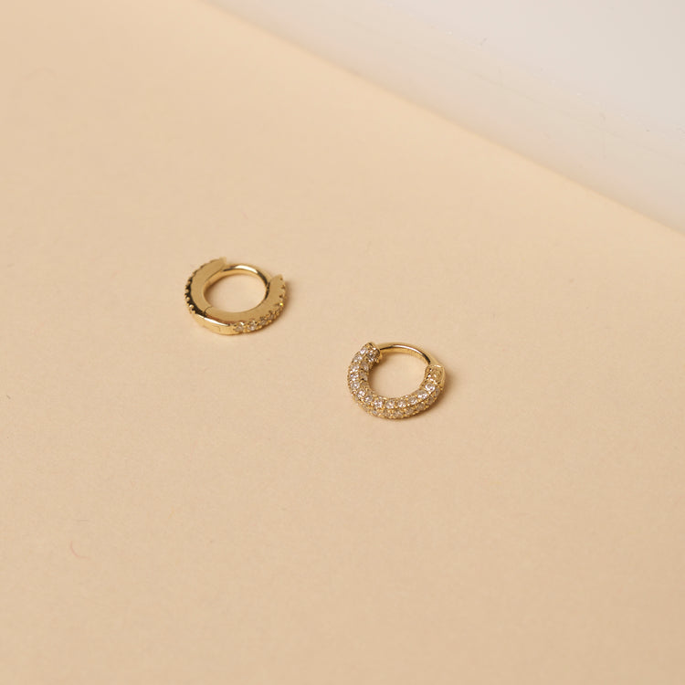 Still life image of Second Hole Teeny White Diamond Pave Eternity Huggie with Stone and Strand solid gold jewelry