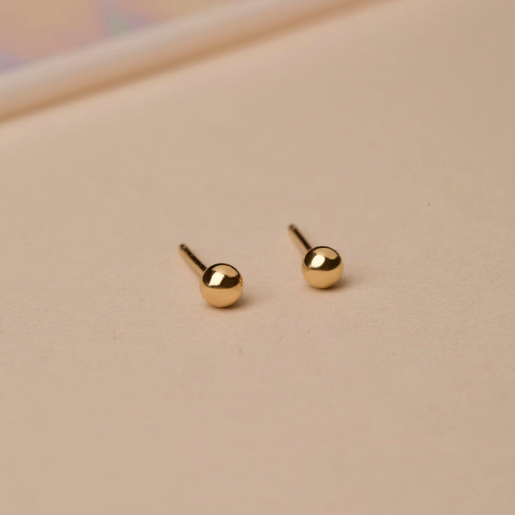 Stone and Strand 14K Yellow Gold Small Gold Bead Earring Editorial Image