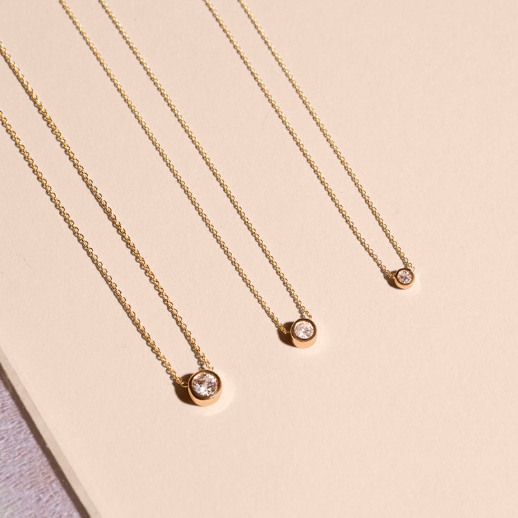 Still life image of Small Round Diamond Necklace with Stone and Strand solid gold jewelry