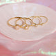 Still life image of Small Round Diamond Ring with Stone and Strand solid gold jewelry