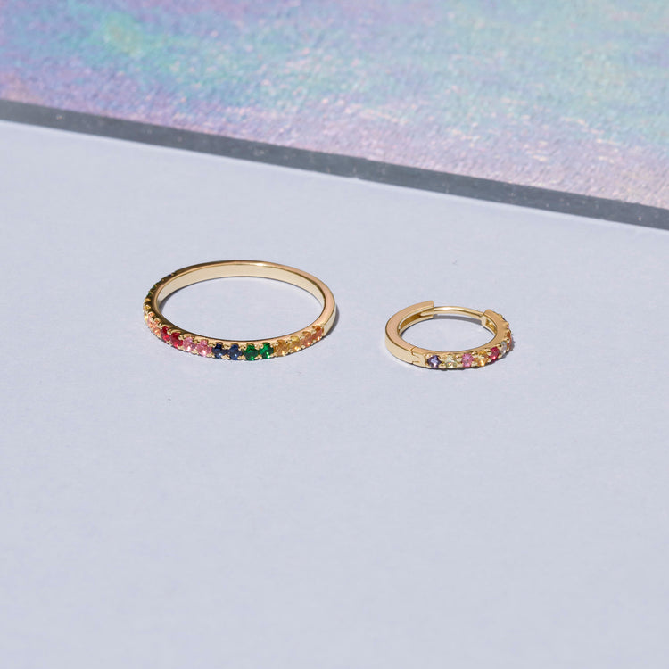 Still life image of Somewhere Over The Rainbow Huggie with Stone and Strand solid gold jewelry