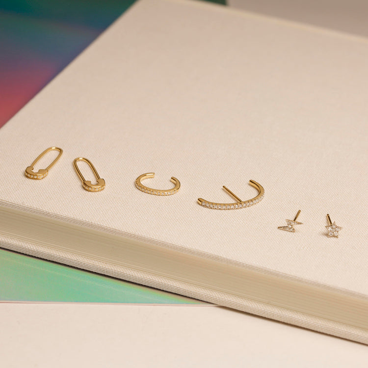 Still life image of Sparkle Safety Pin Earring with Stone and Strand solid gold jewelry