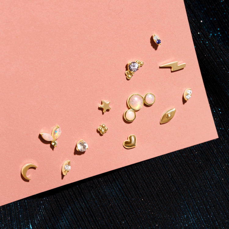 Still life image of Starry Piercing Earring with Stone and Strand solid gold jewelry