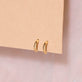 Stone and Strand 10K Yellow Gold Teeny Tiny Gold Huggie Editorial Image