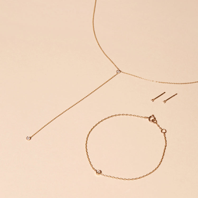 Still life image of Tiny Diamond Lariat Necklace with Stone and Strand solid gold jewelry