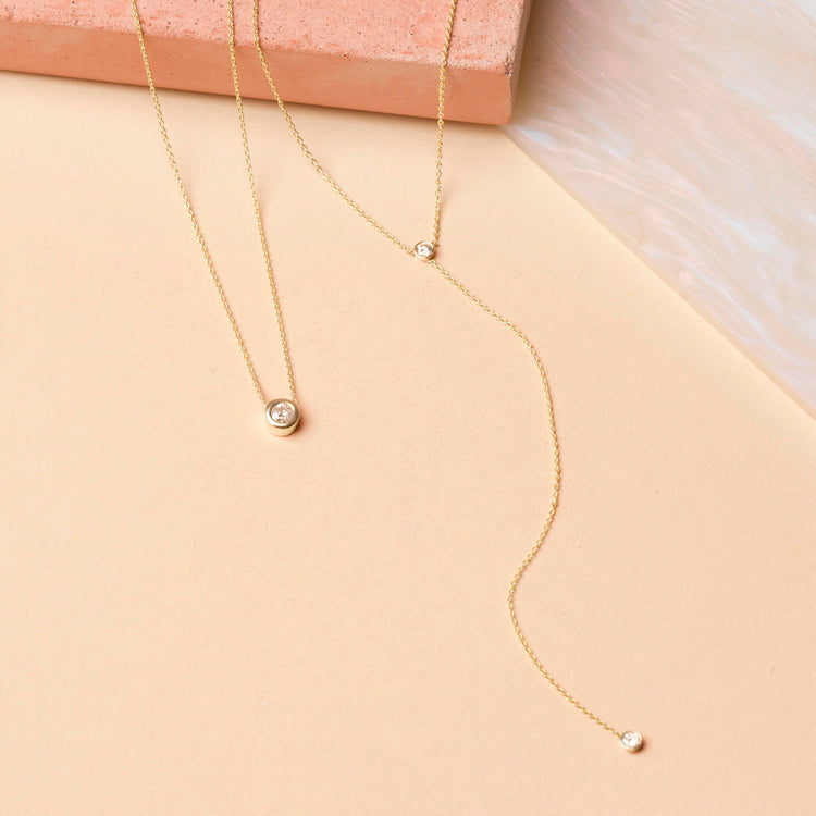 Still life image of Tiny Diamond Lariat Necklace with Stone and Strand solid gold jewelry
