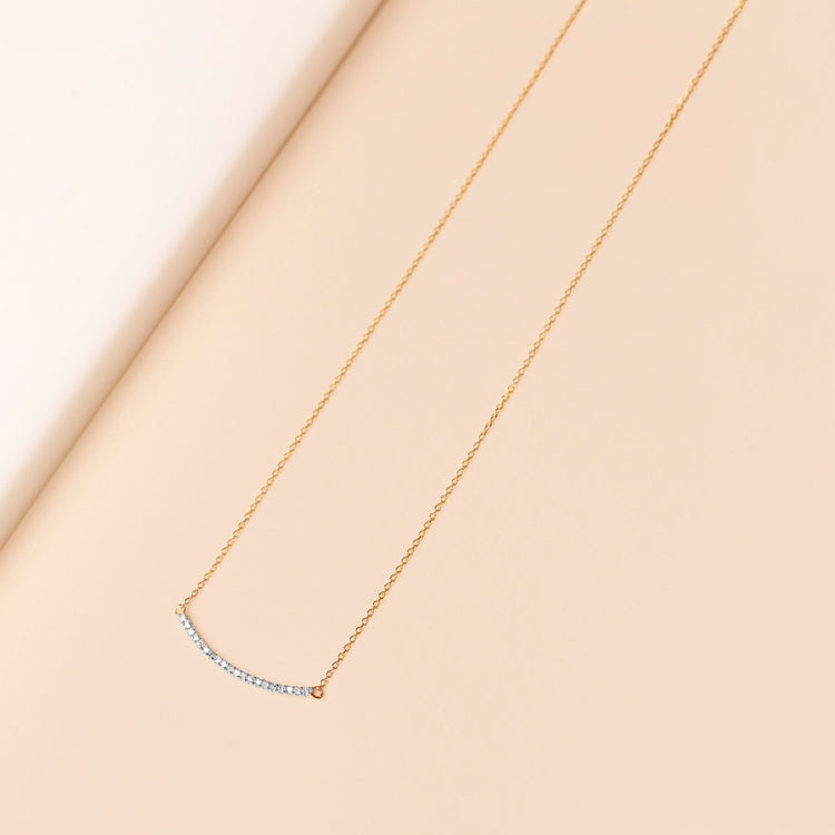 Stone and Strand 10K Yellow Gold Tiny Pave Diamond Curve Bar Necklace Editorial Image