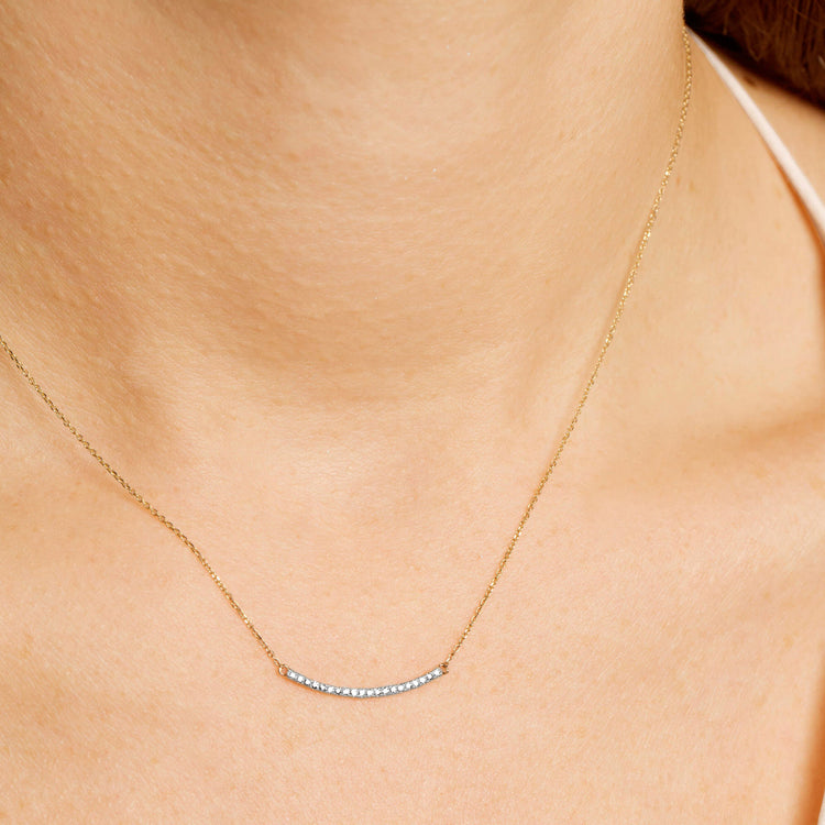 Image of 10K Yellow Gold Tiny Pave Diamond Curve Bar Necklace on Models Neck