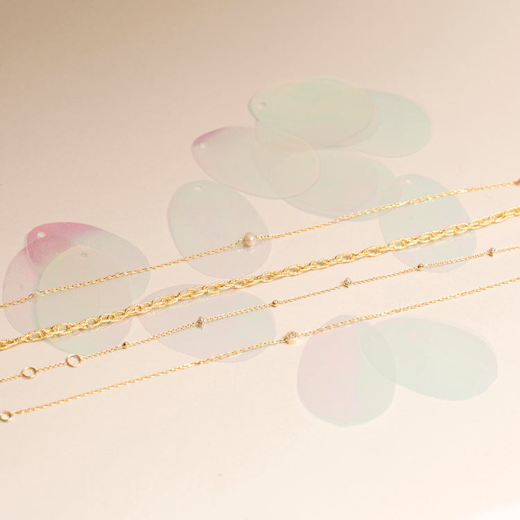 Still life image of Tiny Solitaire Pearl Bracelet with Stone and Strand solid gold jewelry