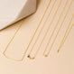 Still life image of Tiny Solitaire Pearl Necklace with Stone and Strand solid gold jewelry