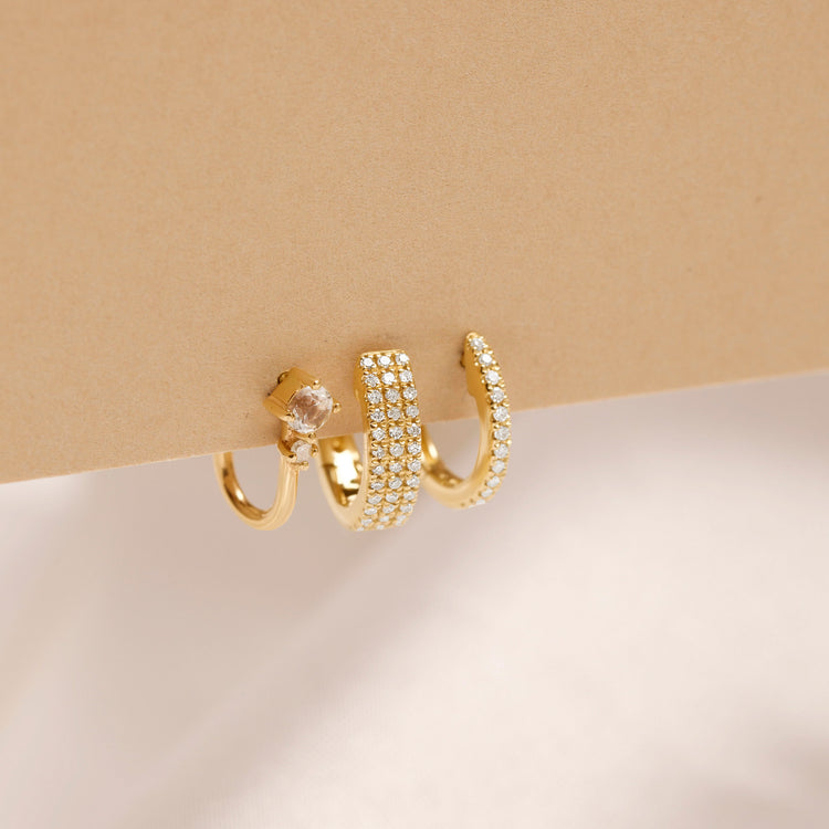 Still life image of Dainty White Diamond Pave Huggie Earrings with Stone and Strand solid gold jewelry