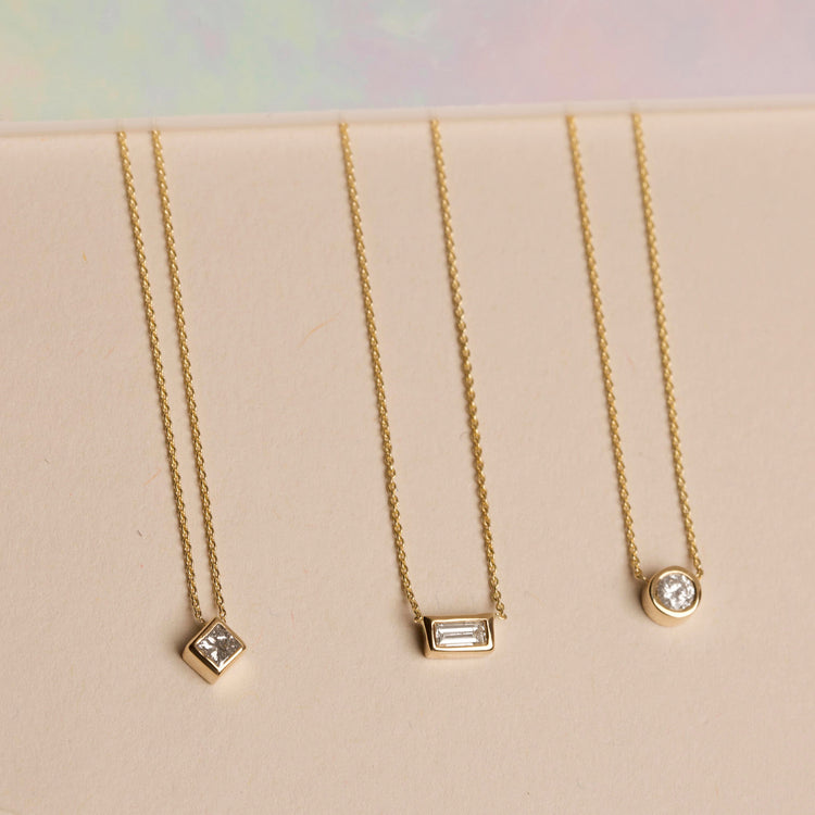 Still life image of Yellow Gold Small Baguette Diamond Necklace with Stone and Strand solid gold jewelry